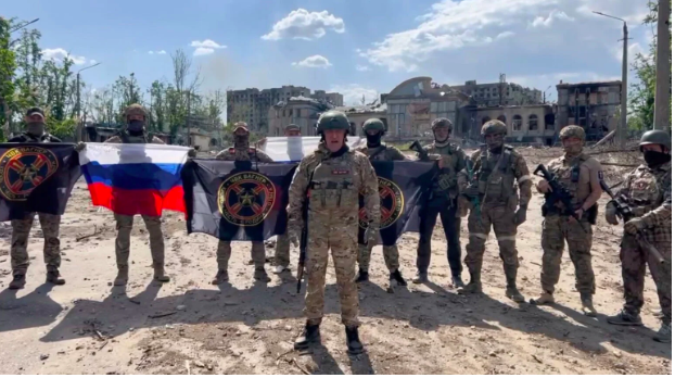 Founder of Wagner private mercenary group Yevgeny Prigozhin makes a statement as he stands next to Wagner fighters in the course of Russia-Ukraine conflict in Bakhmut, Ukraine, in this still image taken from video released on May 20, 2023. Press service of “Concord”/Handout via REUTERS