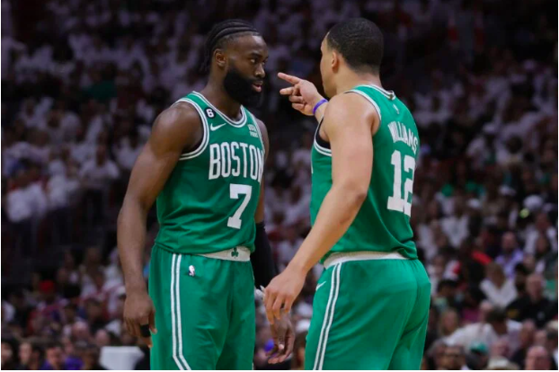 Jaylen Brown #7 and Grant Williams #12 of the Boston Celtics interact against the Miami Heat during the fourth quarter in game four of the Eastern Conference Finals at Kaseya Center on May 23, 2023 in Miami, Florida. Megan Briggs/Getty Images/AFP