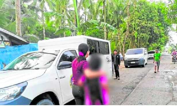 Mother gets 42 years for peddling minor daughters to online sex predators. IN photo are personnel of the Women and Children Protection Center of the Philippine National Police in Samar rescuing one of two girls exposed to cyberpornography by their mother on March 18.