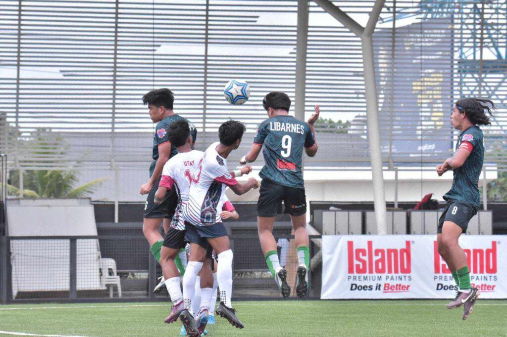 Players from CVFA and SOCSARGEN FA battle for ball possession while in mid-air during their PFF National Championships Group B match.