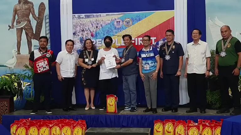 A former drug dependent receives his certificate from Mayor Junard Chan after completing Lapu-Lapu City's drug rehabilitation program. 