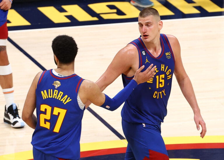 Nikola Jokic #15 and Jamal Murray #27 of the Denver Nuggets react after a 104-93 victory against the Miami Heat in Game One of the 2023 NBA Finals at Ball Arena on June 01, 2023 in Denver, Colorado. Jamie Schwaberow/Getty Images/AFP 