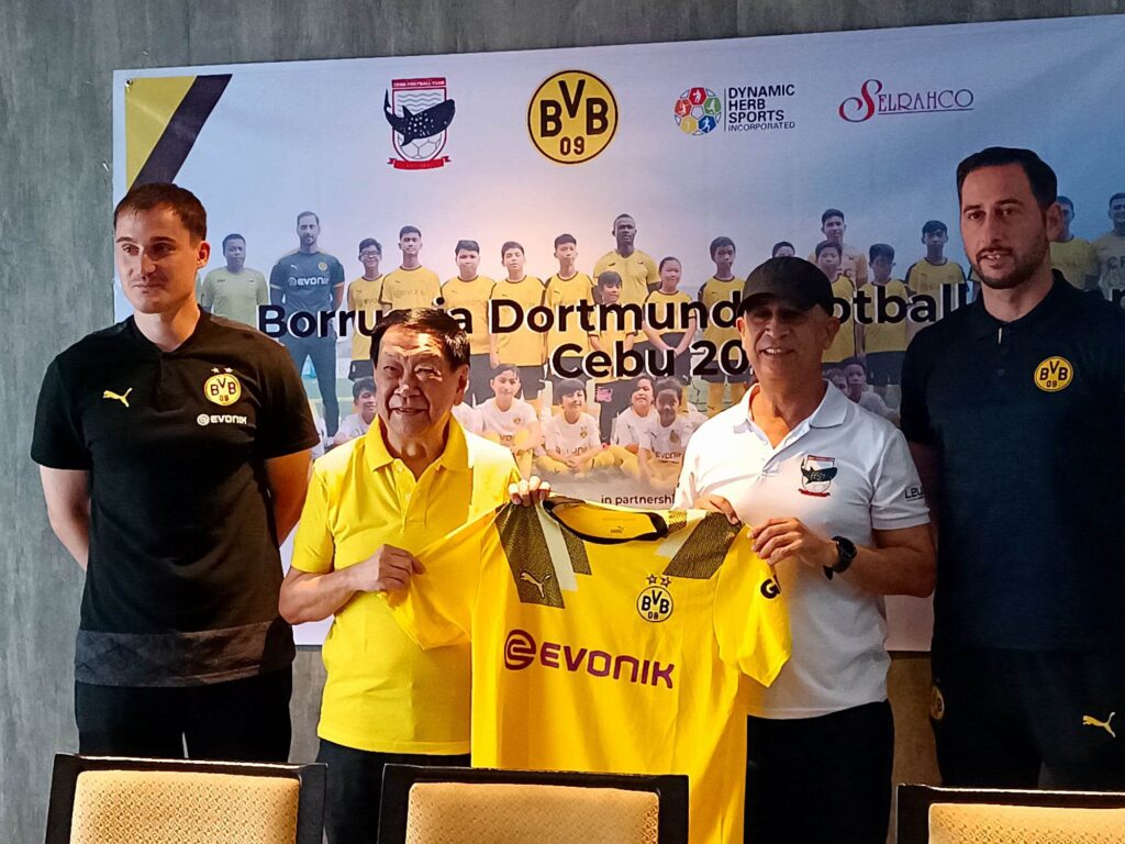 Borussia Dortmund Youth Sector coaches in Niklas Flechsig (leftmost) and Volkan Ozkan (rightmost) flank Selrahco president Charles Lim and Cebu Football Club owner Ugur Tasci who are holding BVB's official jersey in Bundesliga during a presser on Thursday. | Photo by Glendale Rosal