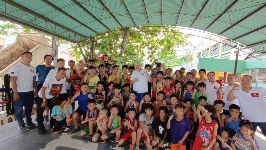 Cebu City Sports Commission's amateur grassroots boxing officials, participants, and Money Punch Fight Promotions Christian Faust (middle wearing white shirt) pose for a group photo during the monthly Cebu City Junior Olympics amateur boxing event. | Contributed photo