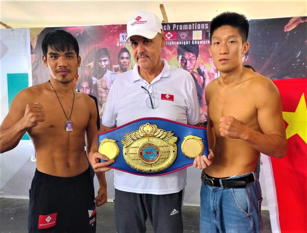 Chinese boxer to Traya in upcoming title fight: I will knock you out in 3 rounds. Elmo Traya (left) and WeiWei Liu (right) of China flank Money Punch Fight Promotions CEO Christian Faust who's holding the WBF Australasian super lightweight title during the fight card's official weigh-in on Friday, June 23, 2023, at the Insular Square, Mandaue City. | Contributed photo