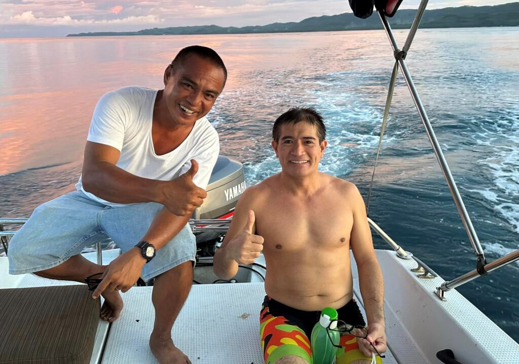 Pinoy Aquaman to try open water swim in Masbate seas on June 24. In photo Ingemar Macarine shows a thumbs-up sign with his assistant after completing his test swim in Masbate for his 10k open water swim on June 24, 2023, there. | Photo from Macarine's Facebook page