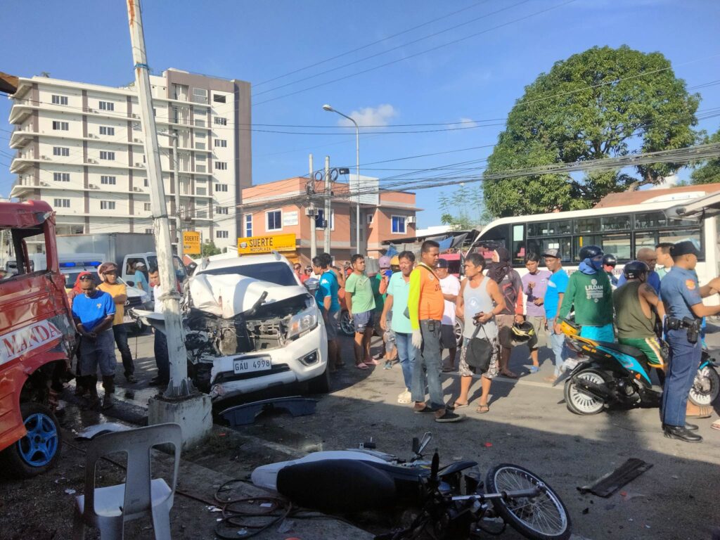 People mill around the accident site in Liloan, Cebu.