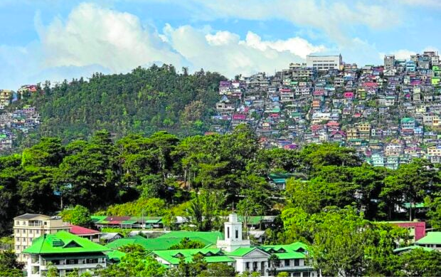 CITY OF PINES | Baguio City has become synonymous with the Benguet pine which thrives despite the intrusion of houses and buildings into the landscape. Residents have been extra protective about Baguio’s pine cover and have supported programs like “Eco Walk” which teaches children about the importance of protecting trees. (Photo by NEIL CLARK ONGCHANGCO / Inquirer Northern Luzon)
