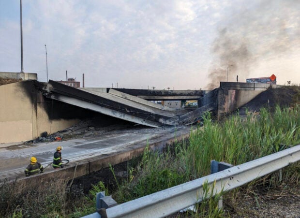 In this handout photo provided by the City of Philadelphia Office of Emergency Management, smoke rises from a collapsed section of the I-95 highway on June 11, 2023 in Philadelphia, Pennsylvania. According to reports, a tanker fire underneath the highway caused the road to collapse.  (Getty Images via AFP)