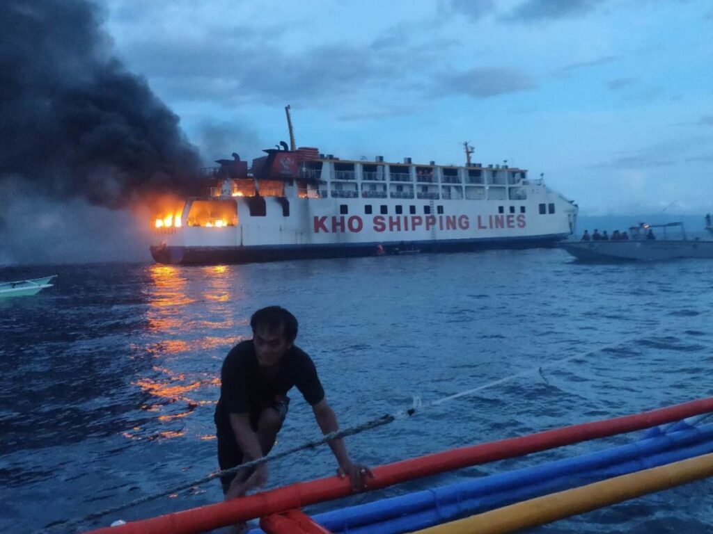 A fisherman prepares to rescue passengers of the MV Esperanza Star which caught fire early this morning, June 18, off the waters of Bohol Province. |PCG Photo