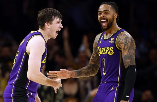(L-R) Austin Reaves #15 and D’Angelo Russell #1 of the Los Angeles Lakers react against the Toronto Raptors in the second half at Crypto.com Arena on March 10, 2023 in Los Angeles, California. Ronald Martinez/Getty Images/AFP