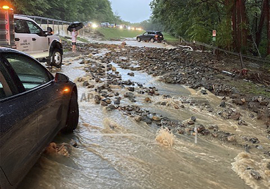 Vehicles come to a standstill near a washed-out and flooded portion of the Palisades Parkway just beyond the traffic circle off the Bear Mountain Bridge, Sunday, July 9, 2023, in Orange County, New York. Heavy rain spawned extreme flooding in New York’s Hudson Valley that killed at least one person, swamped roadways and forced road closures on Sunday night, as much of the rest of the Northeast U.S. geared up for a major storm. 