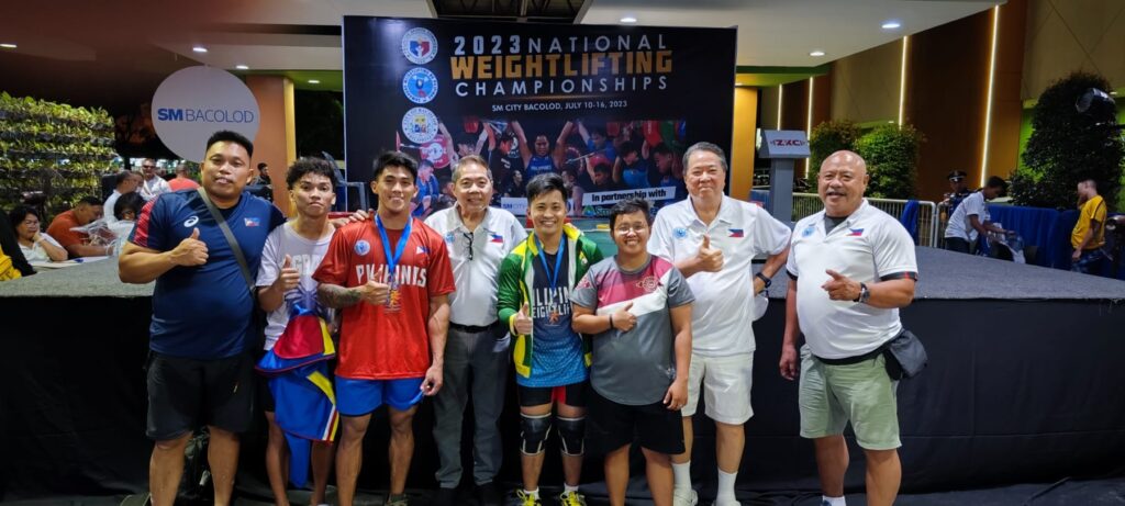 John Febuar Ceniza (in red shirt) poses with his fellow weightlifters, coaches, and SWP officials during the SWP National Weightlifting Championships in Bacolod City.