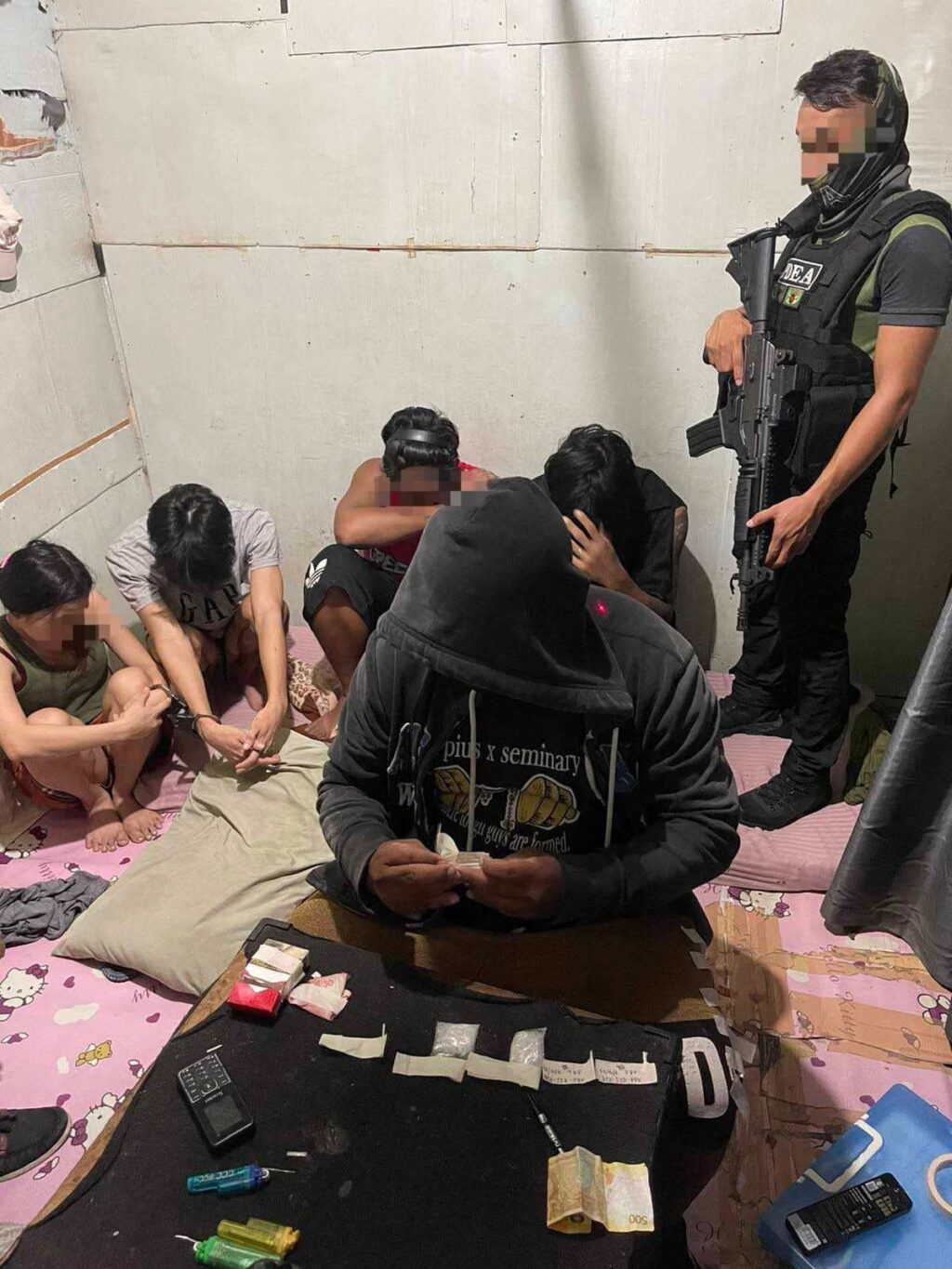 A PDEA-7 agent conducts an inventory of the illegal drugs and drug paraphernalia that were confiscated from a suspected drug den in Barangay Quiot in Cebu City during a buy-bust operation Friday night.