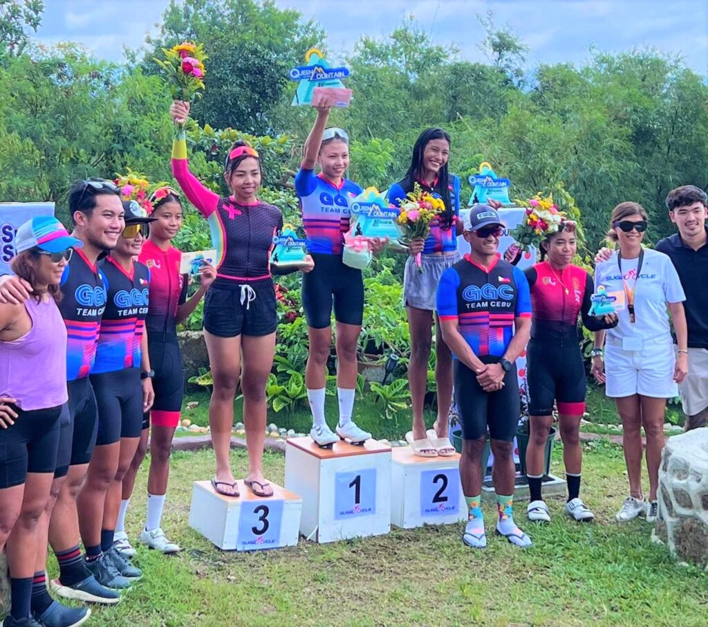 Leslie Gitaruelas (top of the podium) during the awarding ceremony of the Queen of the Mountain road bike race. Joining her are her older sister Lovely (3rd) and Karen Andrea Manayon (2nd), and the organizers from the Sugbo Cycle.