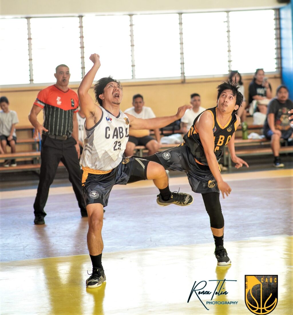 A player of Cebu Home Builders and Kirby Building Systems getting physical while trying to secure a rebound during their CABC 5th Corporate Cup game.