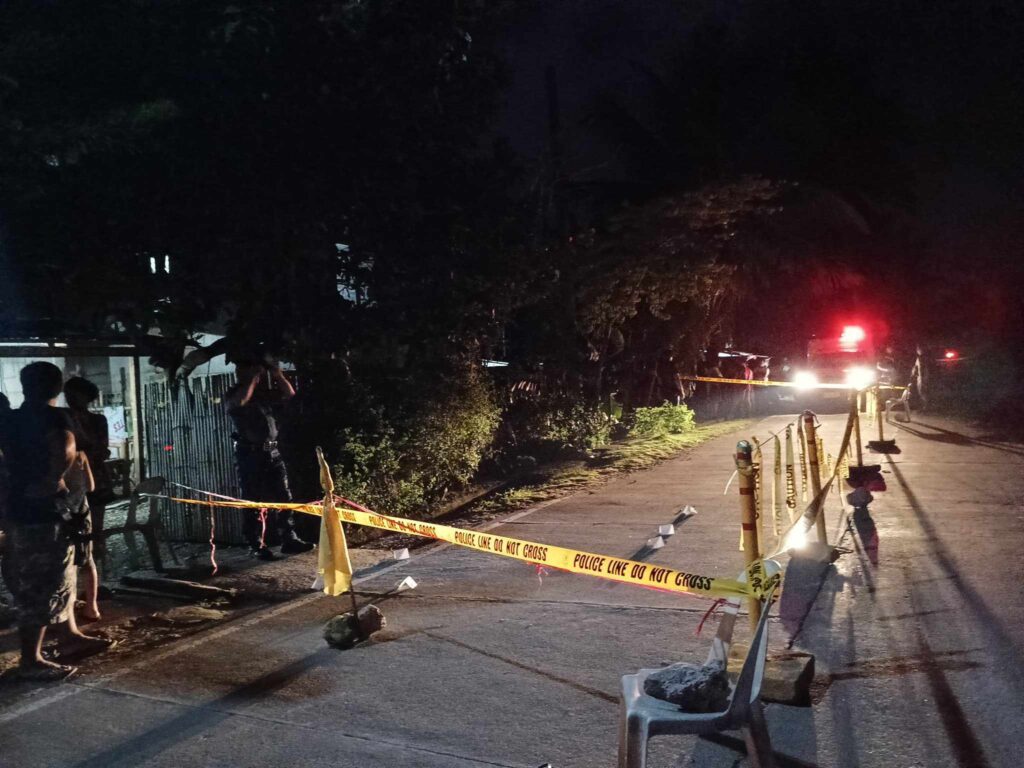 A policeman of the Samboan Police Station processes the crime scene where a fisherman and a former security guard was shot dead by unidentified motorcycle-riding gunmen in Samboan town at past 9 p.m. on July 1. | Samboan Police Station via Paul Lauro