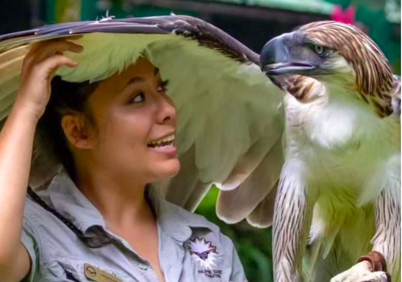 Philippine Eagle, and ambassador of his species, Sinag, with his keeper, Lohwana Halaq, as they share friendly glances inside the premises of PEC in Davao City. | Lohwana Halaq/ IG