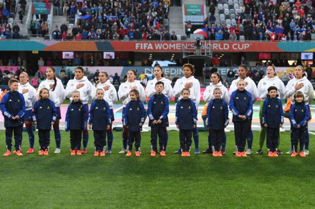 All the ‘firsts’ of the Filipinas in their historic Women’s World Cup campaign. Philippines players observe their national anthem before the Australia and New Zealand 2023 Women’s World Cup Group A football match between the Philippines and Switzerland at Dunedin Stadium in Dunedin on July 21, 2023. (Photo by Sanka Vidanagama / AFP)