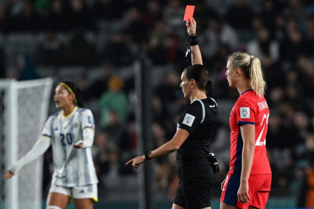 Canadian referee Marie-Soleil Beaudoin (2nd R) shows the red card to Philippines’ defender #16 Sofia Harrison during the Australia and New Zealand 2023 Women’s World Cup Group A football match between Norway and the Philippines at Eden Park in Auckland on July 30, 2023. (Photo by Saeed KHAN / AFP)