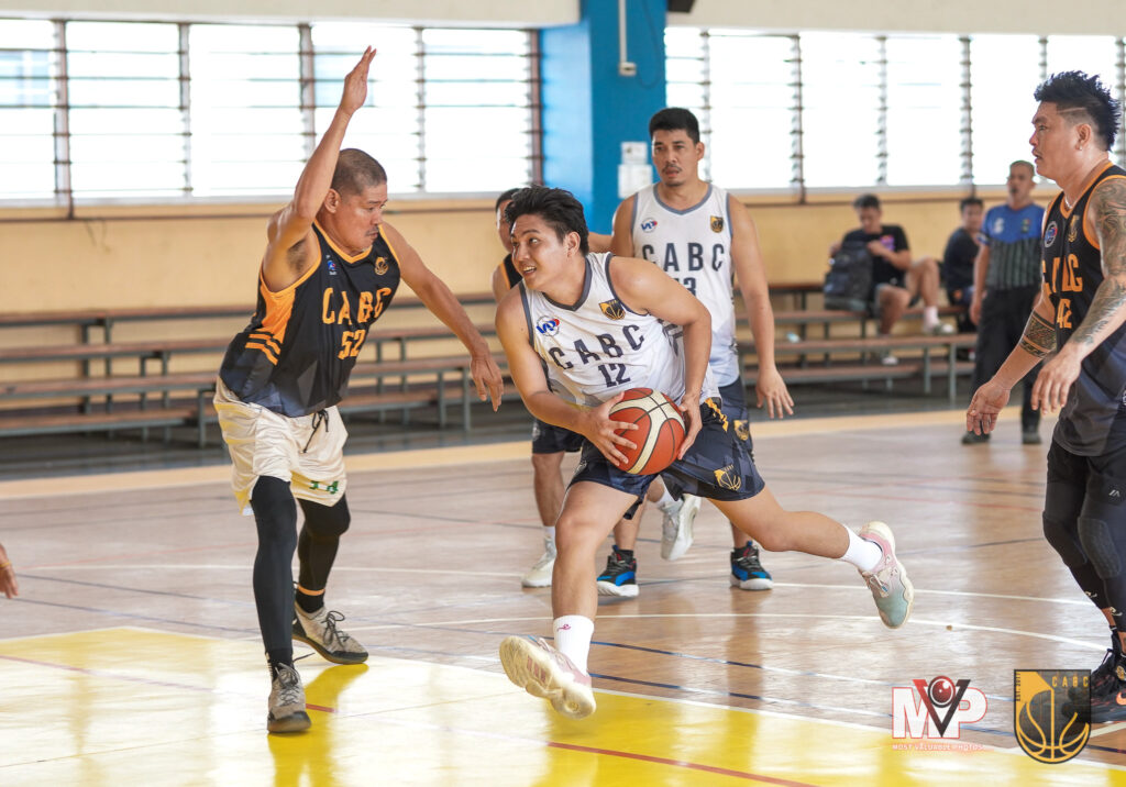 Chester Hinagdanan drives to the basket while being heavily defended during their CABC 5th Corporate Cup game.