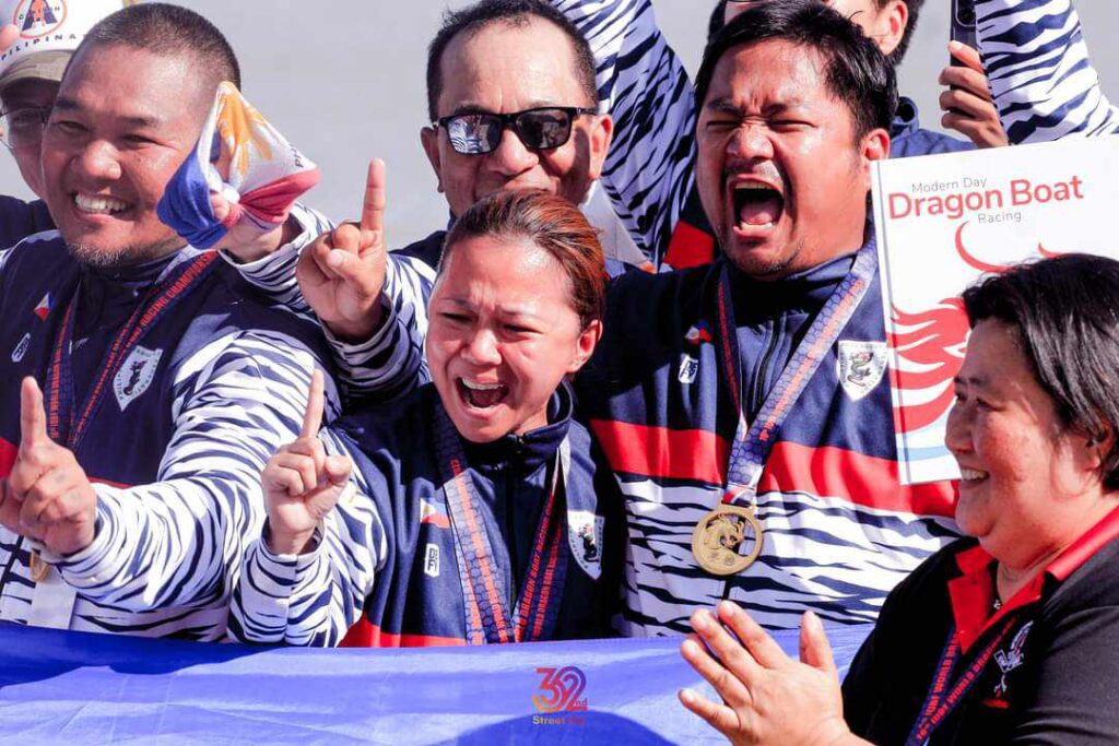PADS team members erupt in celebration during the awarding ceremony of the 16th IDBF World Dragon Boat Racing Championships.
