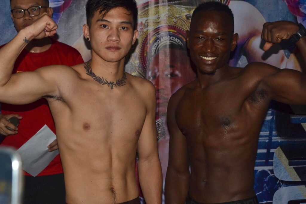 Carl Jammes Martin (left) and Oscar Duge (right) strike a pose after the weigh-in for their 10-rounder bout.