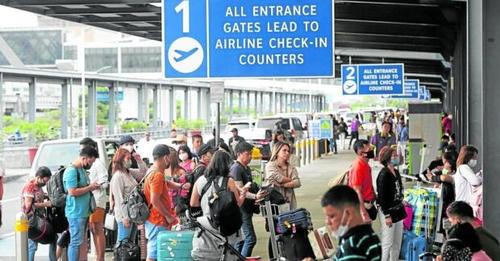 Photo of travelers who are waiting to enter the airport for story: Plane fares poised to rise in Sept on higher fuel costs