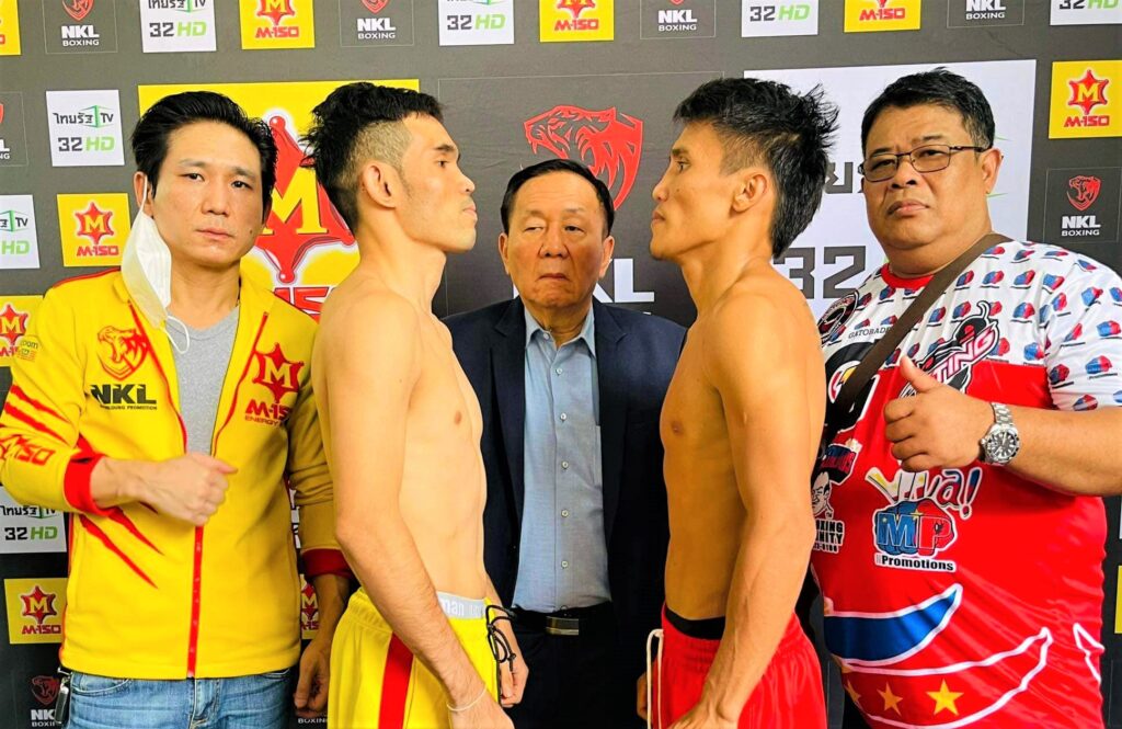 Nawaphon Kaikanha (left) and Vincent Astrolabio (right) engage in a fierce staredown after passing the weigh-in for their world title eliminator bout in Thailand.