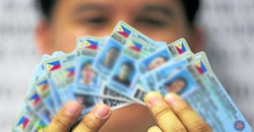 Photo of a man holding severalddrivers’ licenses.