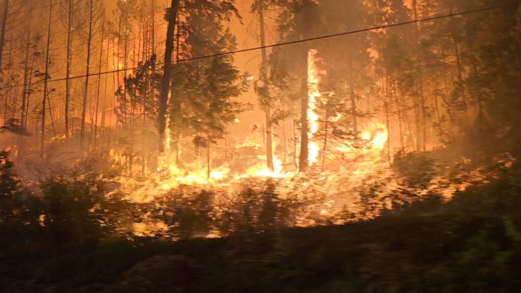 Canadian firefighters wage epic battle to save communities after mass evacuations. In photo is a view of fire close to highway near Sorrento, British Columbia, Canada, August 18, 2023.