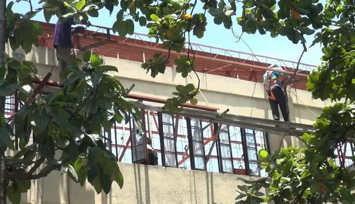 Ongoing repair of one of the buildings of Mandaue City Comprehensive National High School, hit by super typhoon Odette. The building was donated by a private company before, but its repair was funded by the city government. | Mary Rose Sagarino 