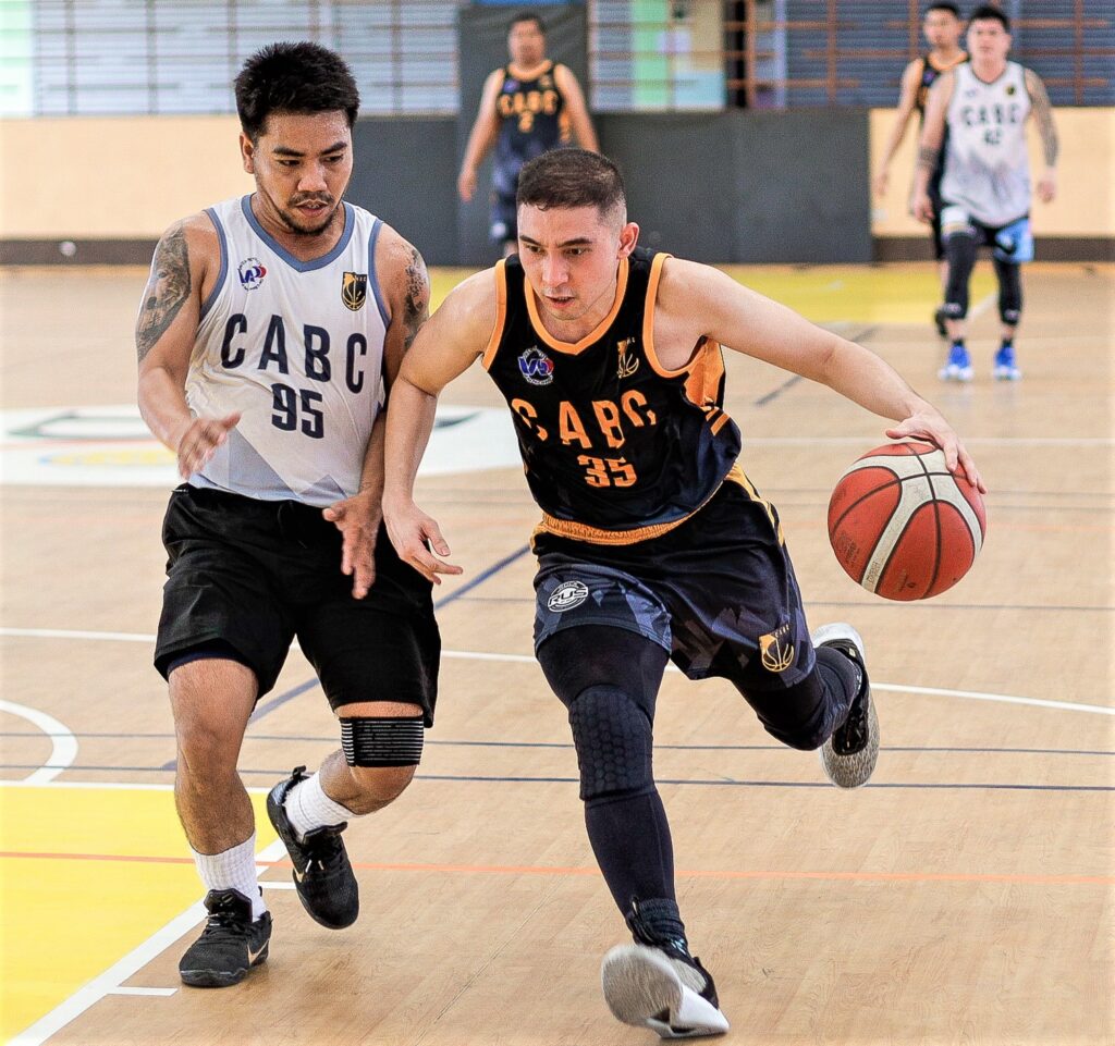 AEG's Zach Elisha Go drives to the basket while being defended by Buildrite during their CABC 5th Corporate Cup game. 