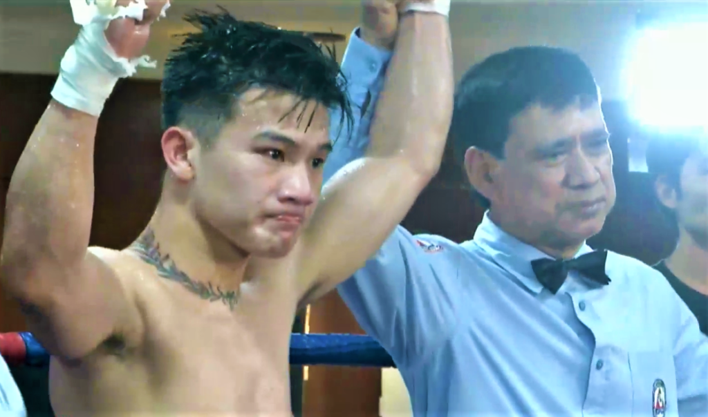 Referee Eddie Nobleza raises Carl Jammes Martin's hand during the announcement of the winner in the latter's bout on Saturday. | Screen grab from the live streaming.