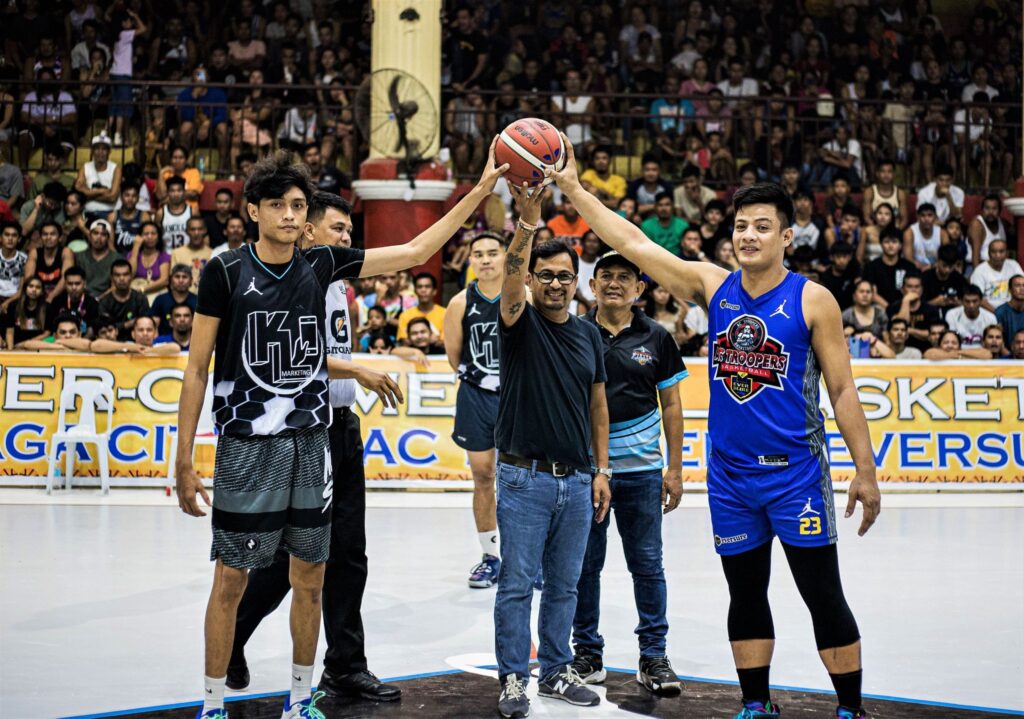 Balamban Mayor Ace Binghay (holding the ball) and Balamban Fiesta Cup Inter-Commercial Basketball Tournament organizer Jun Migallen pose for a photo for the ceremonial toss on Saturday evening's opening game.