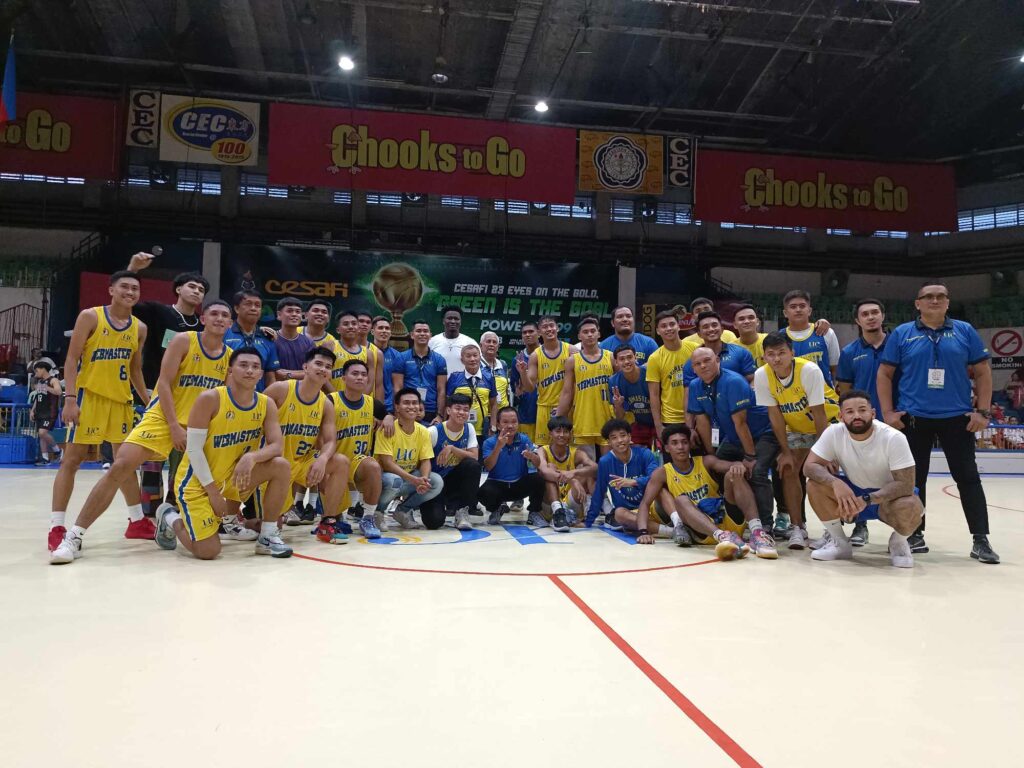 UC Webmasters players and team officials pose at center court after defeating CIT-U in the Cesafi college basketball.