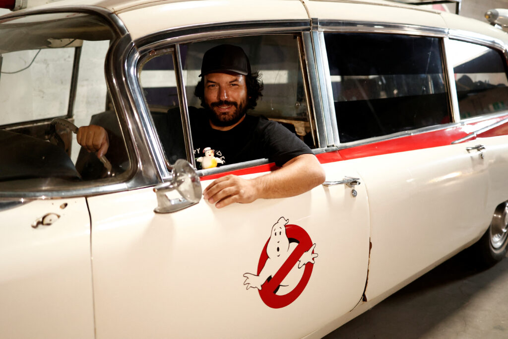 FILE PHOTO: French car collector Franck Galiegue poses in a replica car of the Ghostbusters movie, inside the Pop Central Museum dedicated to legendary vehicles and car replicas from the world of cinema and television in Etrechy, near Paris, France, September 17, 2023. REUTERS/Noemie Olive/File photo