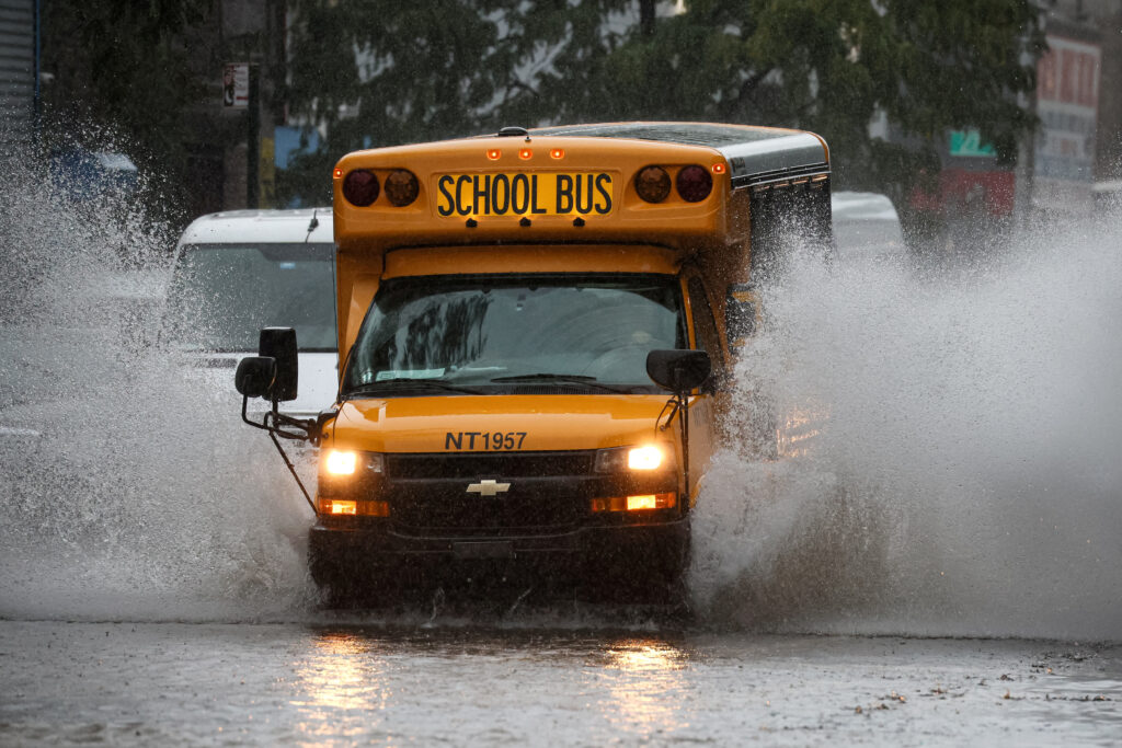 A school bus drives on a flooded street, as the remnants of Tropical Storm Ophelia bring flooding across mid-Atlantic and Northeast, in the Brooklyn borough of New York City, U.S., September 29, 2023.  REUTERS/Brendan McDermid