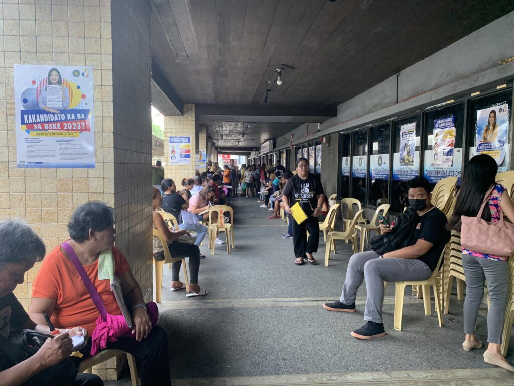 People are outside the office of the Comelec in Cebu City for their appointments.