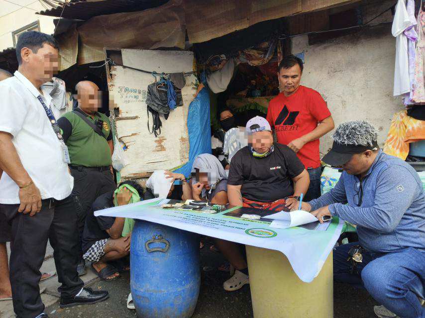 PDEA-7 operatives process the evidence confiscated from suspects after the raid on a suspected drug den allegedly run by a couple in Duljo Fatima, Cebu City on Monday, September 4. | PDEA-7 via Paul Lauro