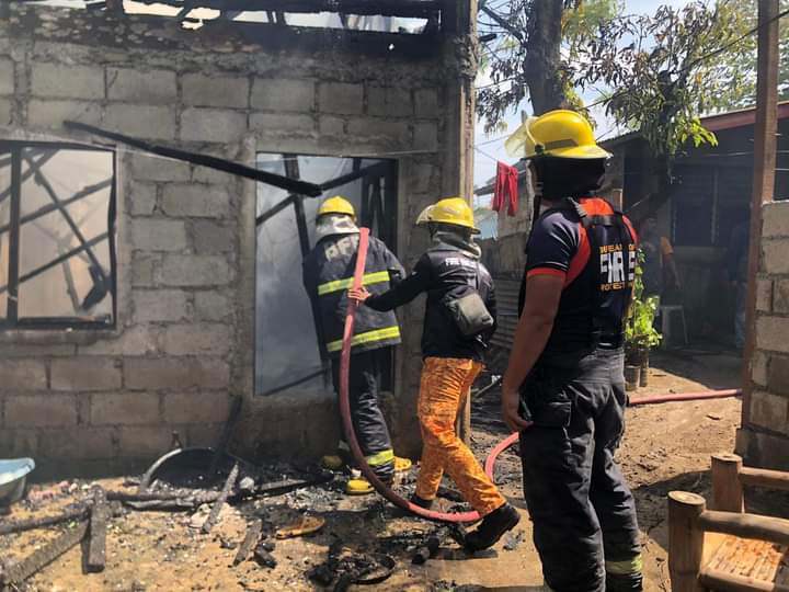 Boy saves sleeping mom, sister from burning house in Minglanilla, Cebu. In photo are Firefighters battling a fire that hit a two-storey house in Barangay Tungkop, Minglanilla town in southern Cebu on September 26, 2023. | Paul Lauro