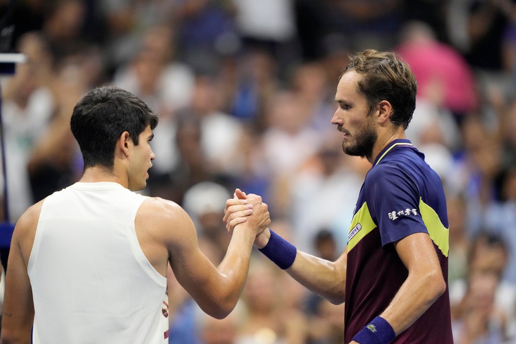 Daniil Medvedev, right, of Russia, shakes hands with Carlos Alcaraz, of Spain, after winning their match during the men’s singles semifinals of the U.S. Open tennis championships, Friday, Sept. 8, 2023, in New York. (AP Photo/John Minchillo)