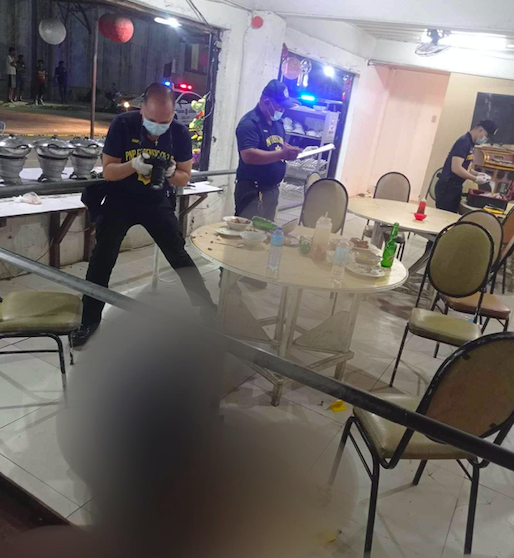 Scene of the Crime operatives process the crime scene where a man, who was eating inside a barbeque grill house in Barangay Tejero was shot dead and his female companion was wounded by a stray bullet and died in the hospital later. | Contributed photo via Paul Lauro