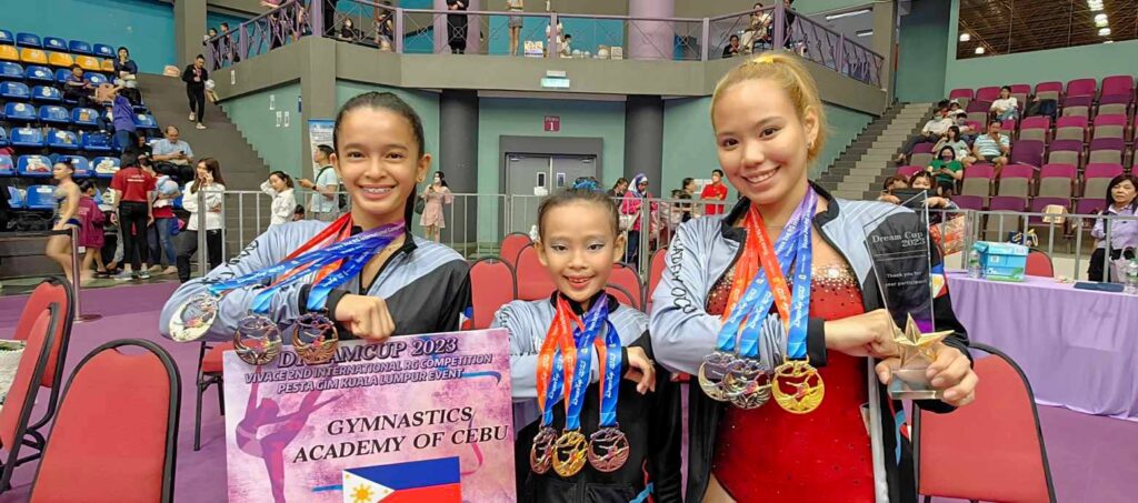 Cebu gymnasts bag 9 gold medals in Malaysia competitions. Mariah Laurrice Cueva (from left), Athena Andrea Adolfo, and Mikhaela Kirsten Silverio of the Cebu Gymnastics Academy pose for a group photo while showing the medals they won in the Dream Cup International Gymnastics Competition in Kuala Lumpur, Malaysia. | Contributed photo