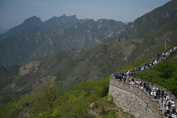 People climb the Great Wall of China at Mutianyu, north of Beijing, on the Labor Day holiday on May 1, 2023. AFP FILE PHOTO