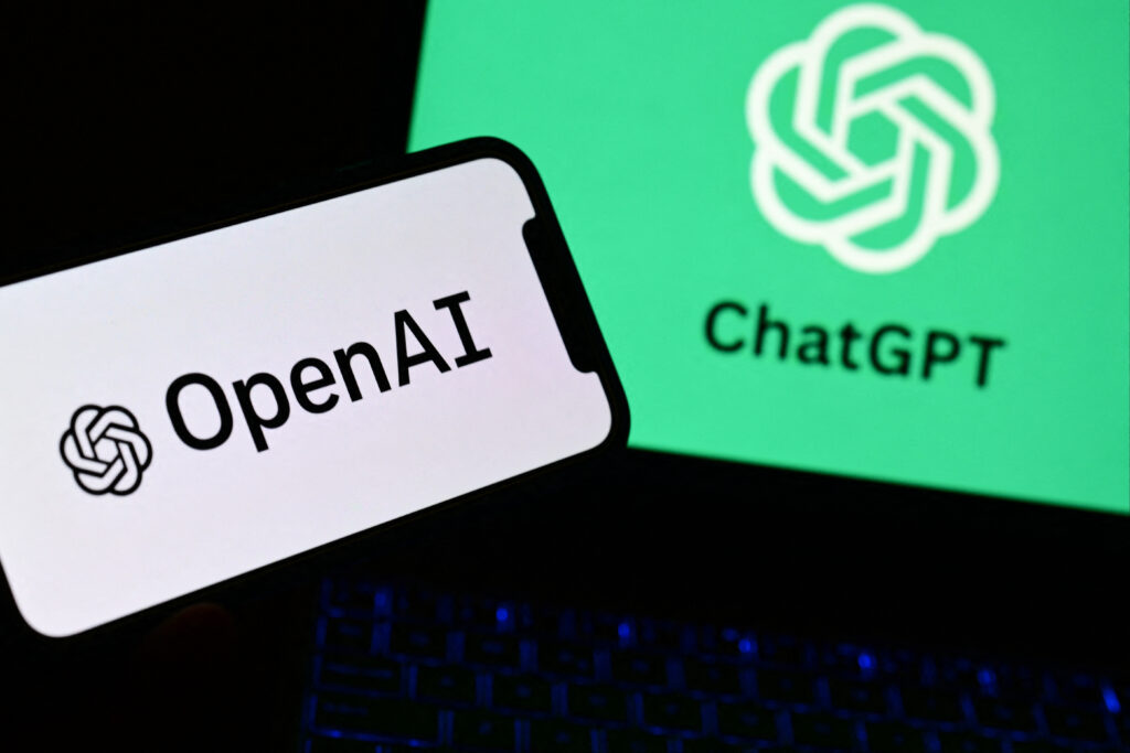 Chatbot. A photo taken on October 4, 2023 in Manta, near Turin,  shows a smartphone and a laptop displaying the logos of the artificial intelligence OpenAI research laboratory and ChatGPT robot. (Photo by MARCO BERTORELLO / AFP)