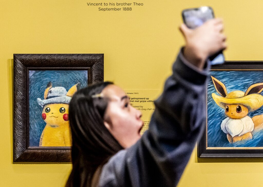 [FILE] People look at paintings by artists inspired by the Pokemon at the Van Gogh museum in Amsterdam, on September 28, 2023. The Vincent Van Gogh Museum in Amsterdam said on October 14, 2023, it would no longer hand out a prized Pokemon card after the giveaway sparked crushes by "scalpers" reselling it for exorbitant prices. | AFP [FILE PHOTO]