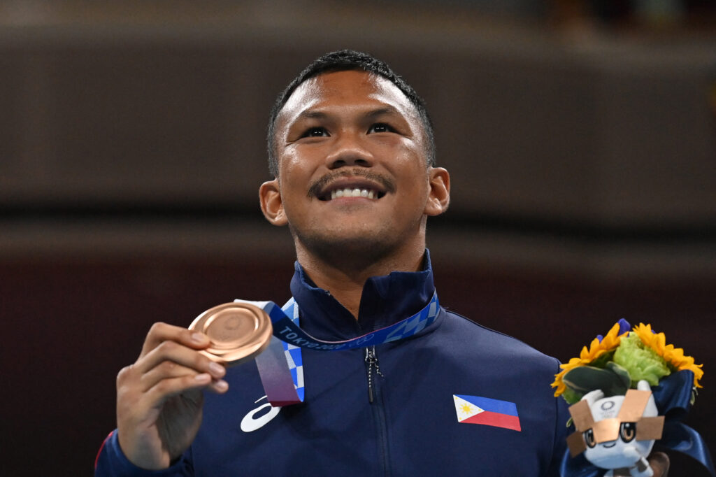 Bronze medallist Philippines' Eumir Marcial celebrates on the podium during the medal ceremony for the men's middle (69-75kg) boxing final bout during the Tokyo 2020 Olympic Games at the Kokugikan Arena in Tokyo on August 7, 2021. (Photo by Luis ROBAYO / POOL / AFP)