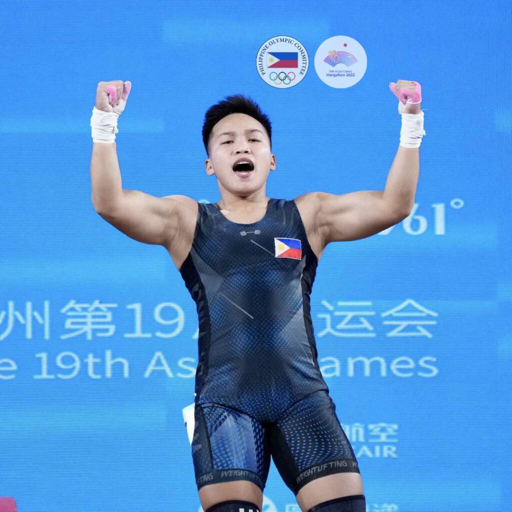 Elreen Ando celebrates after winning a bronze medal during the women's 64kgs weightlifting competition in the Asian Games.