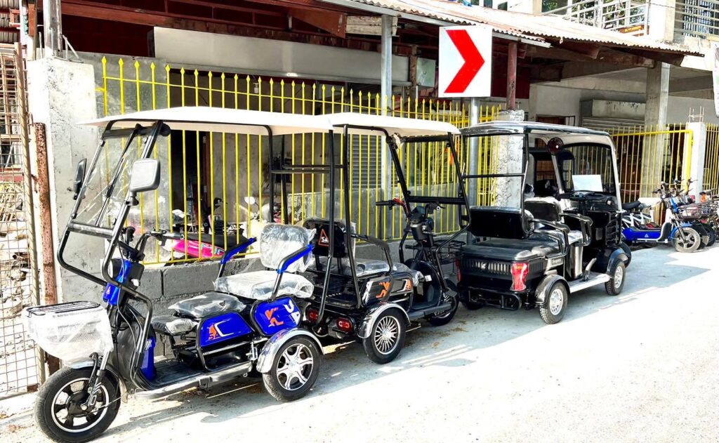Photo showing e-trikes that are parked along the road in Cordova town.
